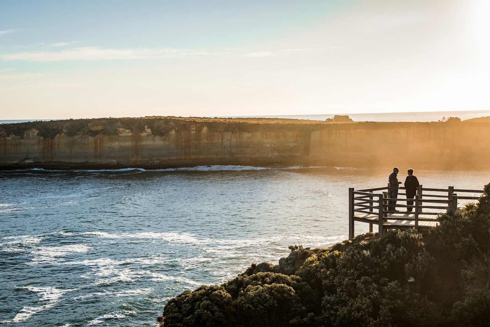 Mother and daughter looking out over a sunny Australian coastline